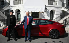 US President Donald Trump and Tesla CEO Elon Musk speak to the press as they stand next to a Tesla vehicle on the South Portico of the White House on March 11, 2025 in Washington, DC. (Photo by Mandel NGAN / AFP)