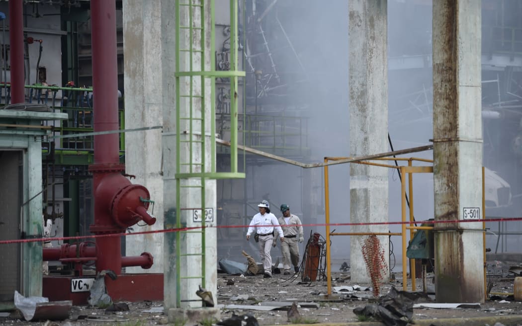 Workers search for victims a day after an explosion at the state-run oil giant Pemex's Pajaritos petrochemical plant in Coatzacoalcos, Veracruz State, Mexico