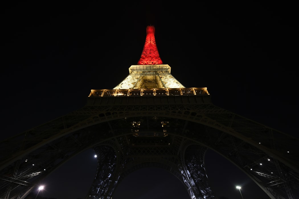The Eiffel tower in Paris lights up in the Brussels national colours of black, yellow and red.
