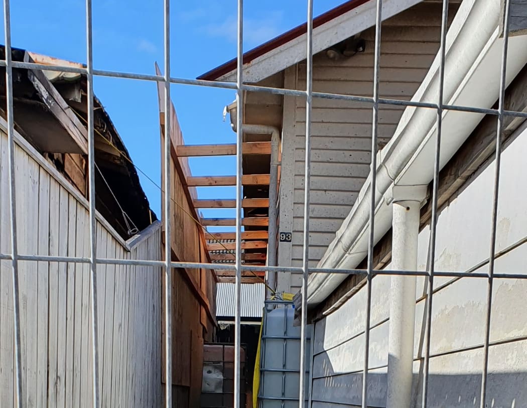 Temporary fencing and ply sheets confront Vanila Ekenasio on daily trips back to her Kilbirnie home to feed the cat, Beauty, who has refused to leave.