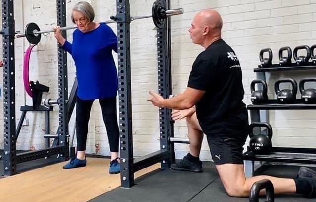 Dean Mawby and a client at Real Strength Gym.
