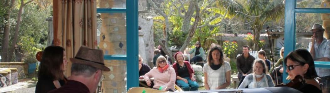 This is an image  people in the garden, listening