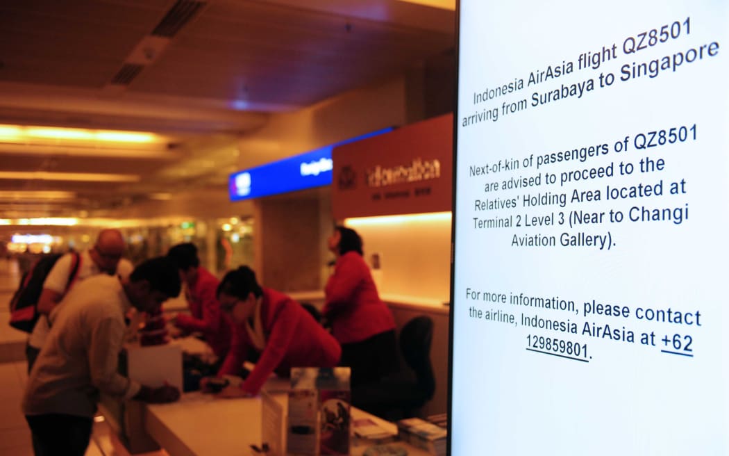 An electronic sign board shows information for AirAsia flight QZ8501 bound for Singapore International Airport on December 28, 2014.
