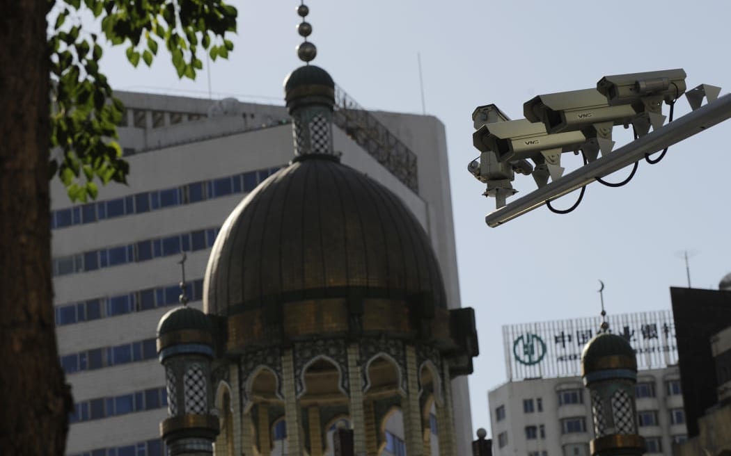 Security cameras are seen on a street in Urumqi, capital of China's Xinjiang region on July 2, 2010. Photo: Peter Parks / AFP