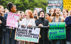 Protestors with banners at the Climate Strike at Parliament April 2021: "You Know it's a Problem when it's Hotter than Me", "If You Don't Believe in Climate Change Your Mom's a Hoe", and "Hot Climax not Hot Climate".