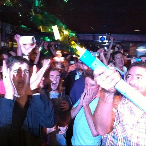 Supporters of the bill celebrate at a bar in central Auckland.