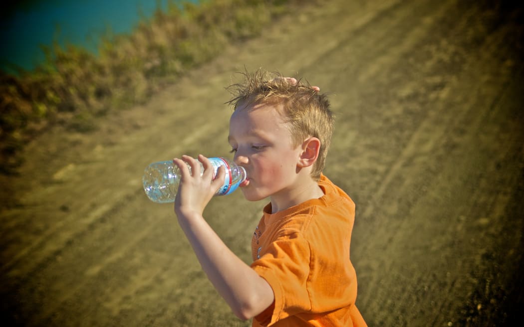 Boy drinking bottle of water