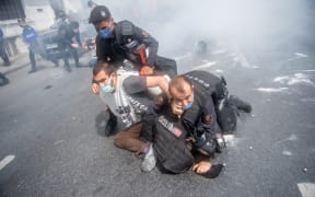 Turkish police detain demonstrators as they attempted to march on Taksim Square in Istanbul.