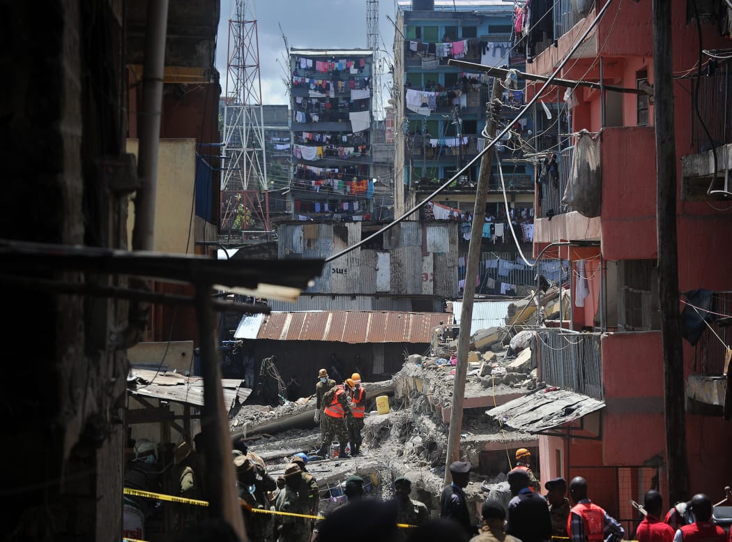 Security and rescue personel continue to search for bodies trapped in rubble.
