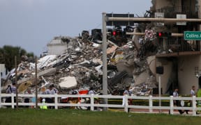 Rubble is piled high after the partial collapse of the 12-storey Champlain Towers South condo building on 24 June 2021 in Surfside, Florida.