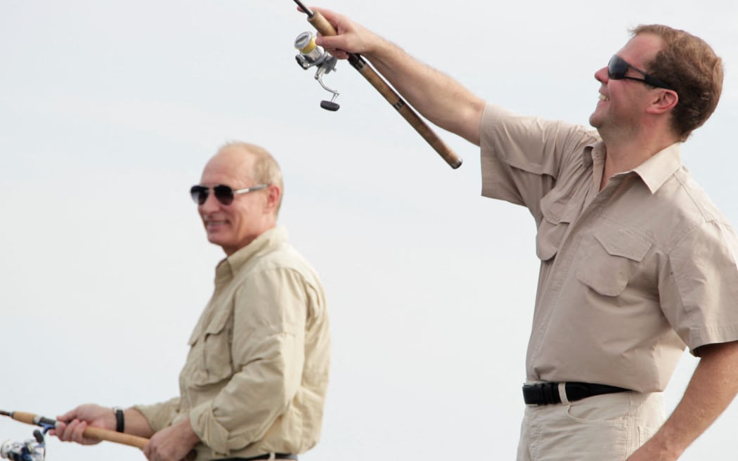 Russian President Dmitry Medvedev (R) and Prime Minister Vladimir Putin fish on holiday on the Volga River in Astrakhan region, about 1280 kilometers south from Moscow on August 16, 2011.