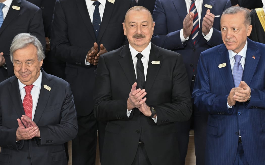 Participating world leaders and delegates, including United Nations (UN) Secretary General Antonio Guterres, Azerbaijan's President Ilham Aliyev and Turkey's President Recep Tayyip Erdogan, pose for a family photo during the United Nations Climate Change Conference (COP29) in Baku on November 12, 2024. (Photo by Alexander NEMENOV / AFP)