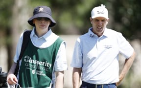 Steven Alker of New Zealand and his son and caddie Ben Alker