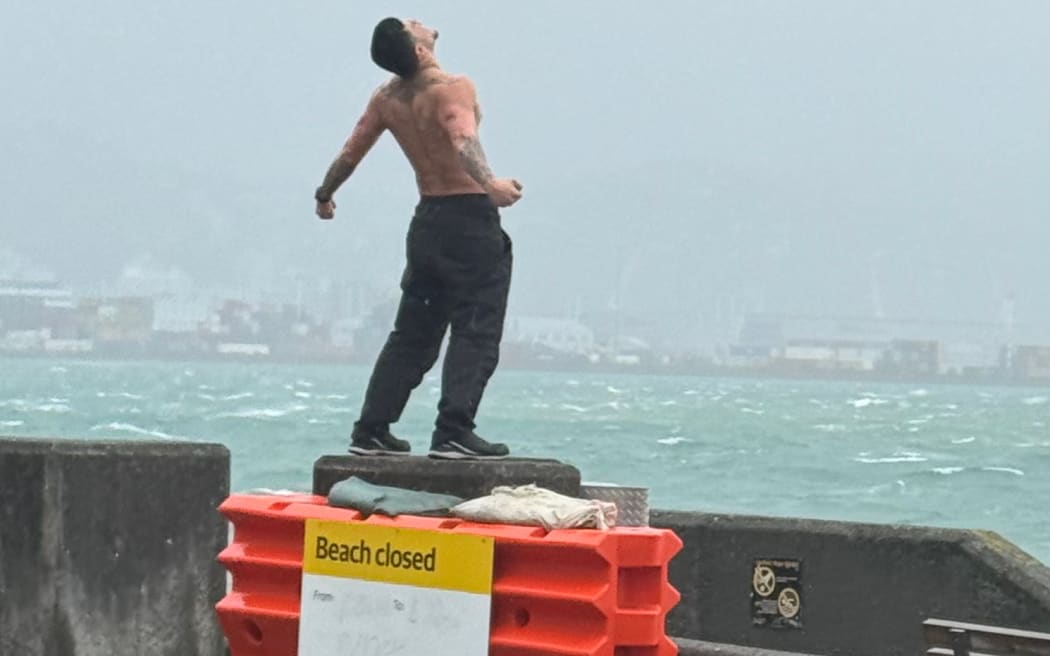 A man bares his chest in Oriental Bay, Wellington, during storms last week.