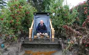 Local machinery operator Cameron Young clearing silt from a Puketapu orchard on 24 January 2023 before the rain set in.