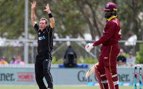 New Zealand's Doug Bracewell celebrates the wicket of Chris Gayle.