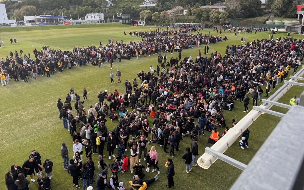 Crowds of registered participants gather outside Eden Park on the oval.