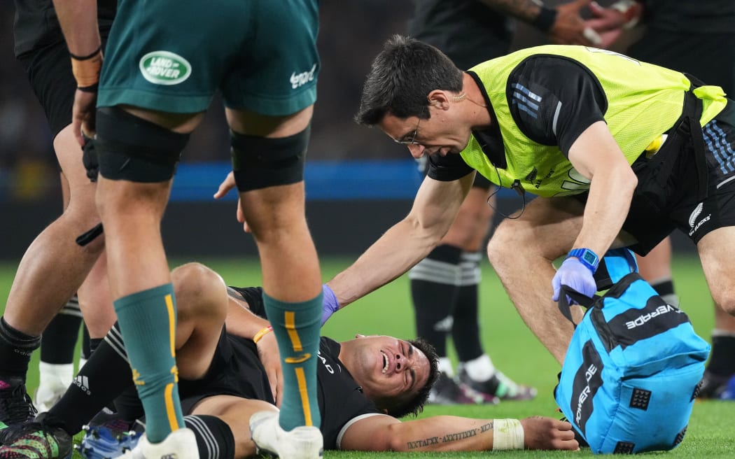 All Blacks midfielder Quinn Tupaea goes down injured against the Wallabies in Melbourne.