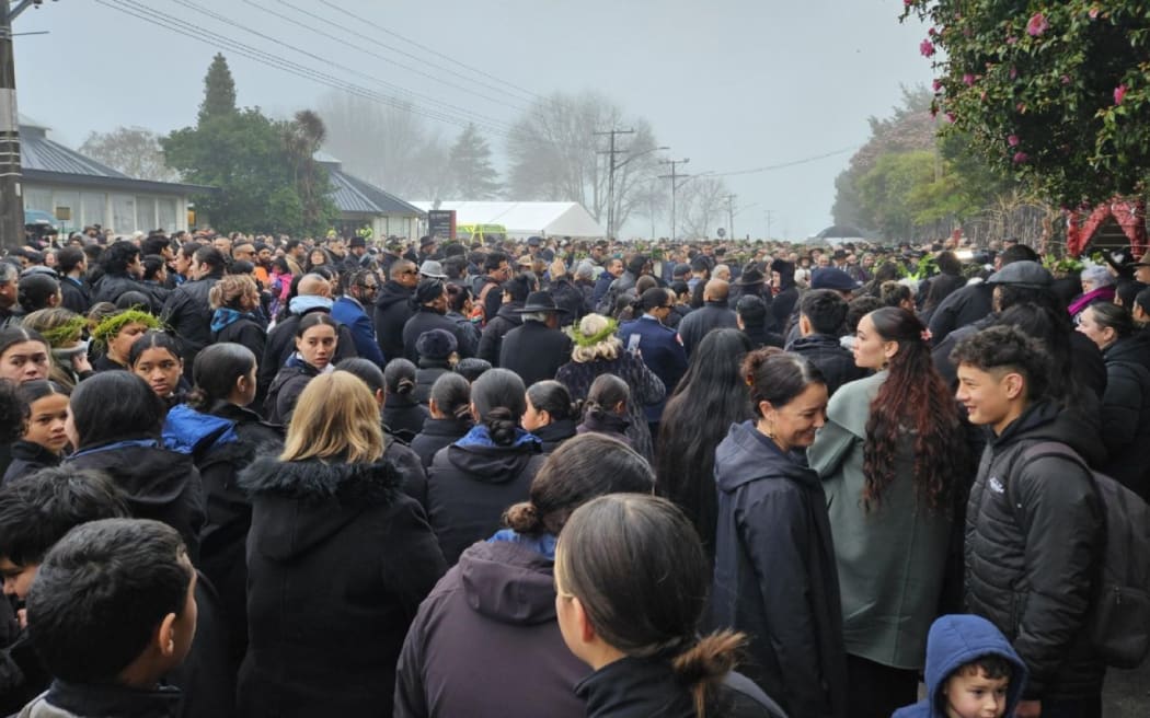 People wait outside the gates of Tuurangawaewae on day four of Kiingi Tuheitia's tangi, September 2024.