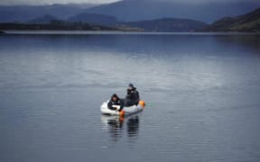 Police-led search specialists on Lake Wanaka during the operation to recover the body of crashed pilot Matt Wallis.