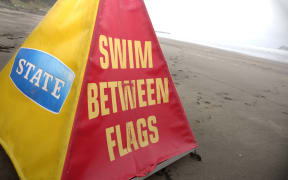 Swimmers at Auckland's Muriwai Beach are told to 'swim between the flags'.