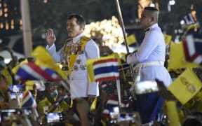 Thai King Maha Vajiralongkorn greets supporters as he walks to participate in a candle lighting ceremony in remembrance of late Thai King Bhumibol Adulyadej's birthday anniversary at Sanam Luang in Bangkok, Thailand, 05 December 2020.