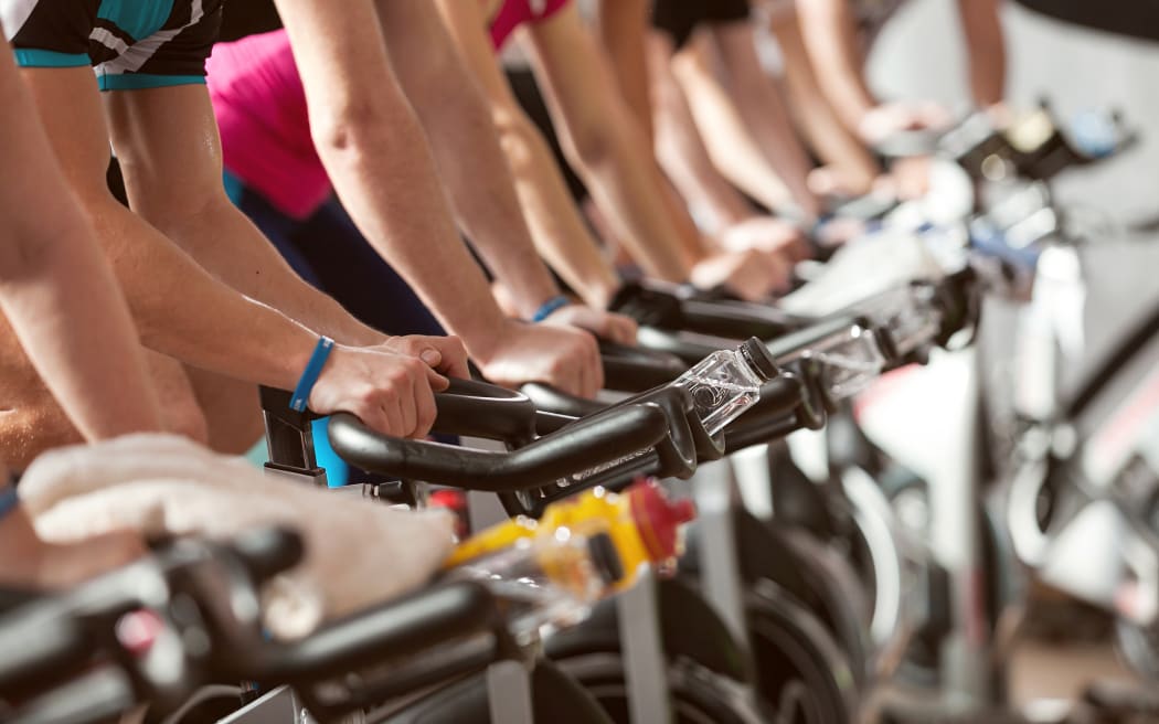 gym detail shot - people cycling; spinning class