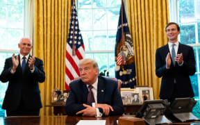 US President Donald Trump, flanked by Vice President Mike Pence (left) and Advisor Jared Kushner, announcing that Bahrain will establish diplomatic relations with Israel, at the White House in Washington, DC on 11 September, 2020.