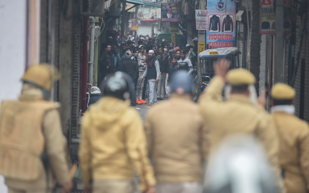 Police face protesters gathering to demonstrate against India's new citizenship law in New Delhi on December 17, 2019.
