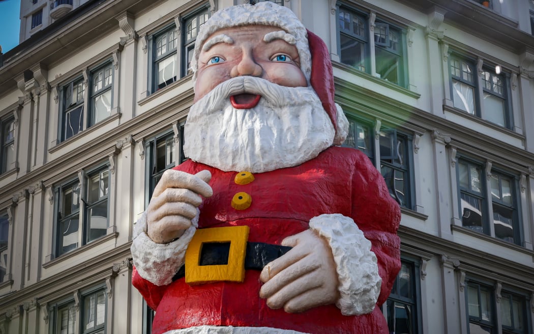 Large santa statue mounted to a building in Auckland's central city.