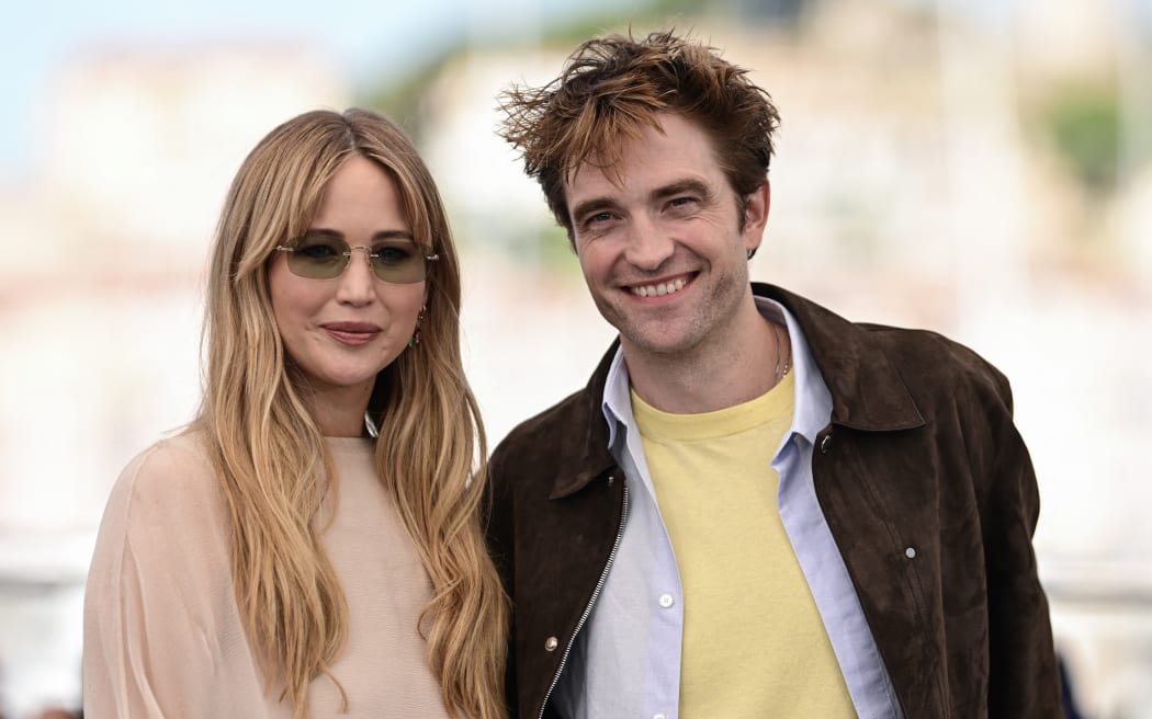 US actress Jennifer Lawrence and British actor Robert Pattinson pose during a photocall for the film "Die, My Love" at the 78th edition of the Cannes Film Festival in Cannes, southern France, on May 18, 2025. (Photo by Miguel Medina / AFP)