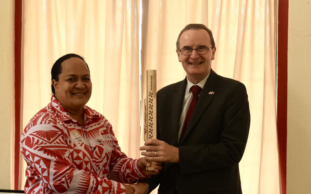 TASANOC Secretary-General and CEO Mrs Netina Latu Vea presents the Tonga baton to British High Commissioner His Excellency Mr. Philip Malone.