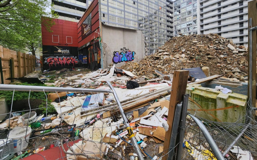 The front of a building that has rubbish strewn in front of it.