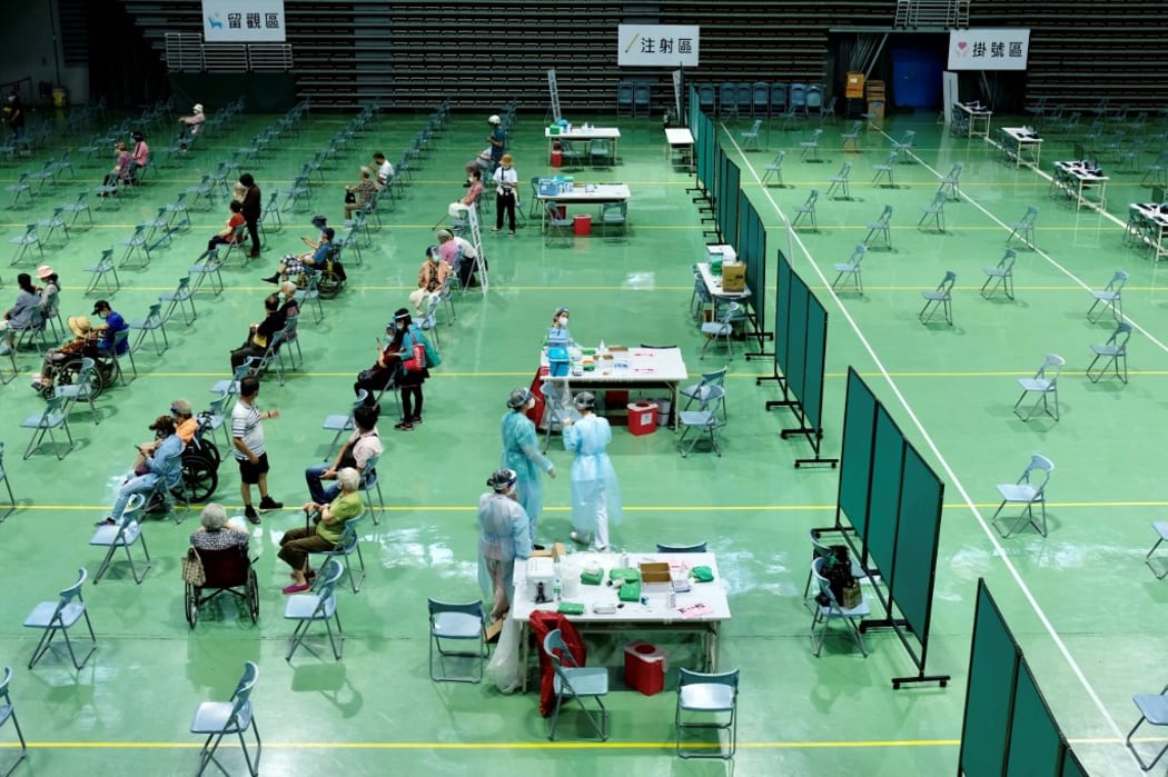 Elderly people await to be vaccinated against Covid-19 coronavirus at the Hsinchuang Stadium in New Taipei City on June 15, 2021. (Photo by Sam Yeh / AFP)