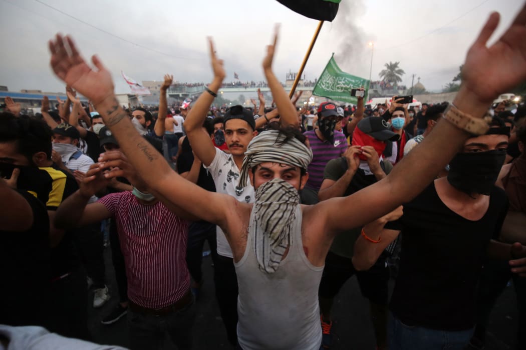 Iraqi protesters chant slogans during a demonstration against state corruption, failing public services and unemployment at Tayaran square in Baghdad.