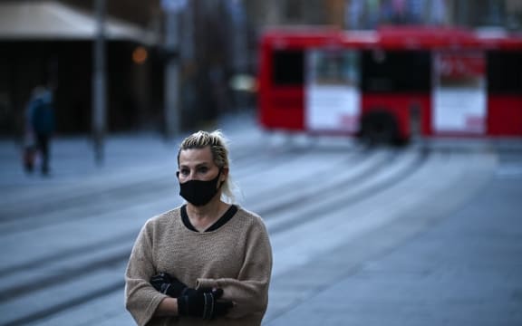 SYDNEY, AUSTRALIA - JUNE 26: A woman wearing mask walks at partially empty Sydney Central Business District during the first day of lockdown in Sydney, Australia, Saturday, June 26, 2021.