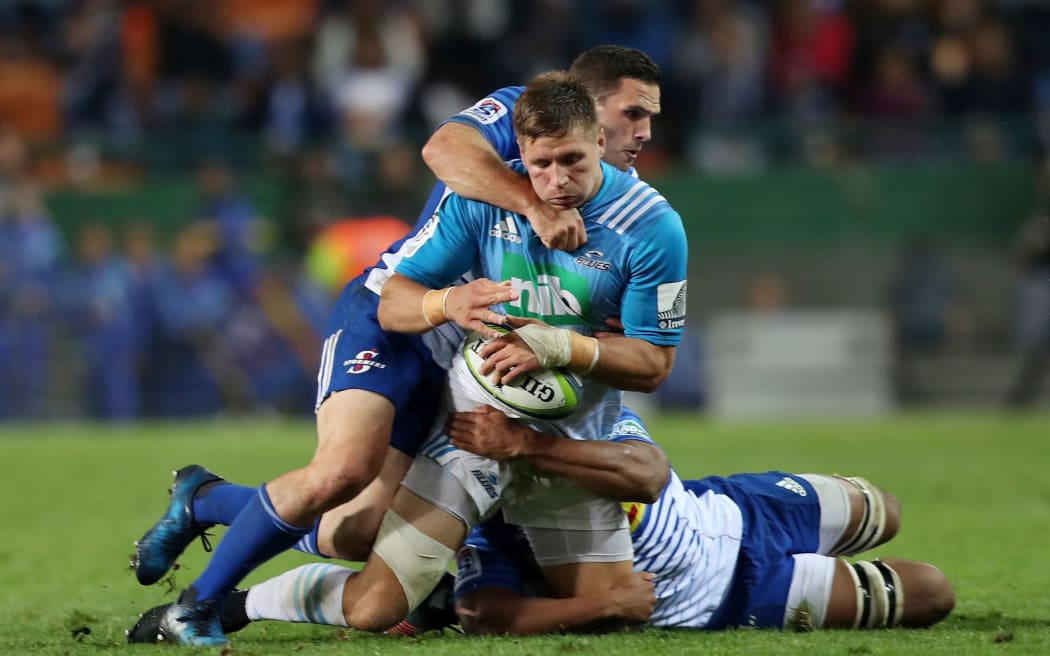 Blues player Piers Francis tackle by Shaun Treeby of the Stormers in their Super Rugby game.