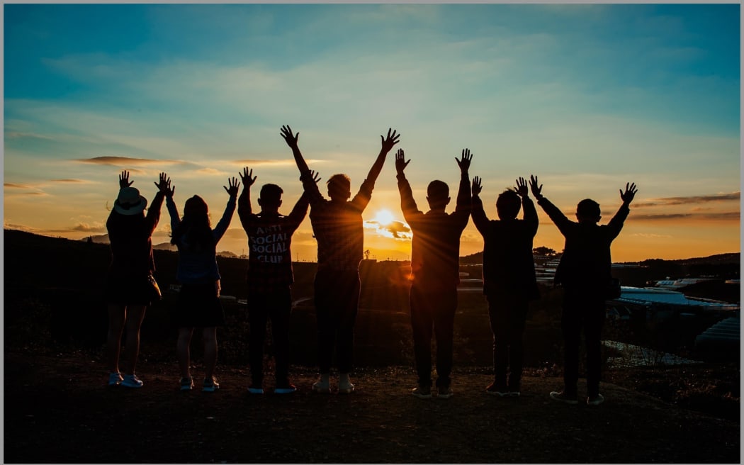 Teenagers at the beach at sunset