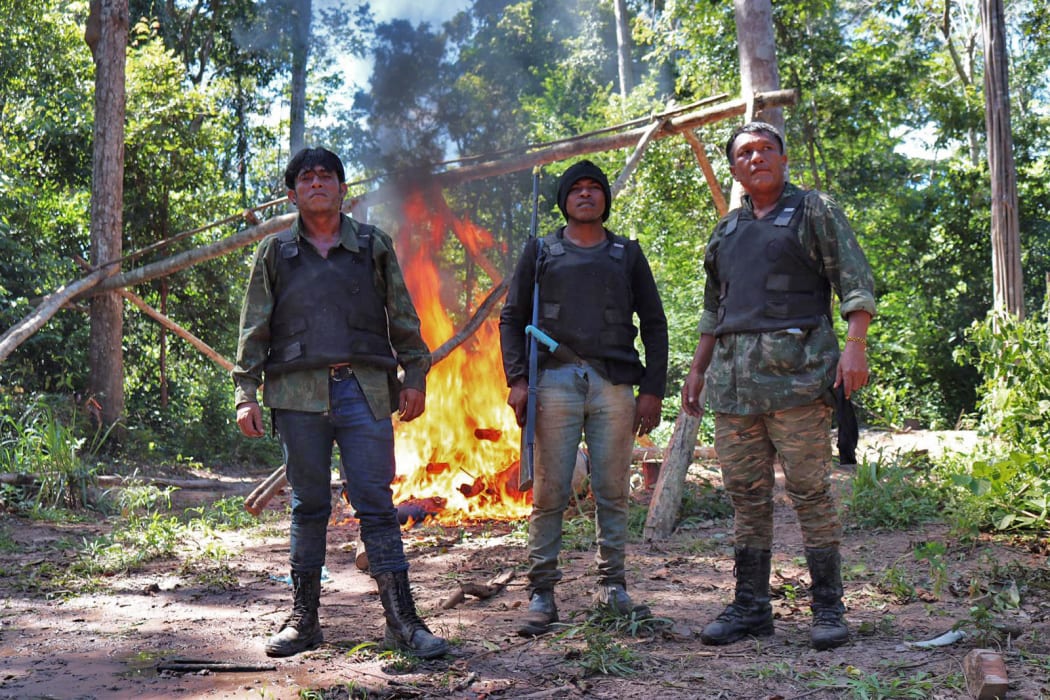 Brazilian indigenous men (L-R) Laercio Guajajara, Paulo Paulino Guajajara and Olimpio Guajajara, members of the "Guardians of the Forest" group, in Arariboia indigenous territory, Maranhao state.