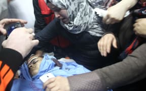 Relatives mourn over the body of Palestinian Mohammed Fares al-Jaabari who died near the Israeli settlement of Kiriat Arba.