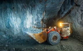 Working inside gold mine tunnel. Gold mining.
