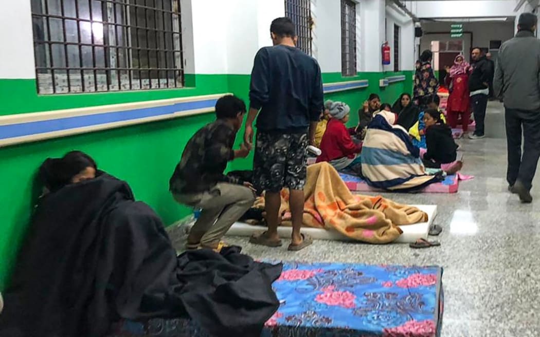 Survivors are seen at a corridor of the Jajarkot district hospital in the aftermath of an earthquake in Jajarkot on November 4, 2023. More than 60 people were killed when a shallow 5.6-magnitude earthquake hit a remote pocket of Nepal, officials said early on November 4. The tremor hit the far west of the Himalayan country late Friday and was measured by the US Geological Survey at just 18 kilometres (11 miles) deep. (Photo by Balkumar Sharma / AFP)