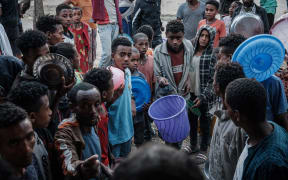 Displaced civilians wait to receive food in Mekele, the capital of Tigray region, Ethiopia, on June 21, 2021.