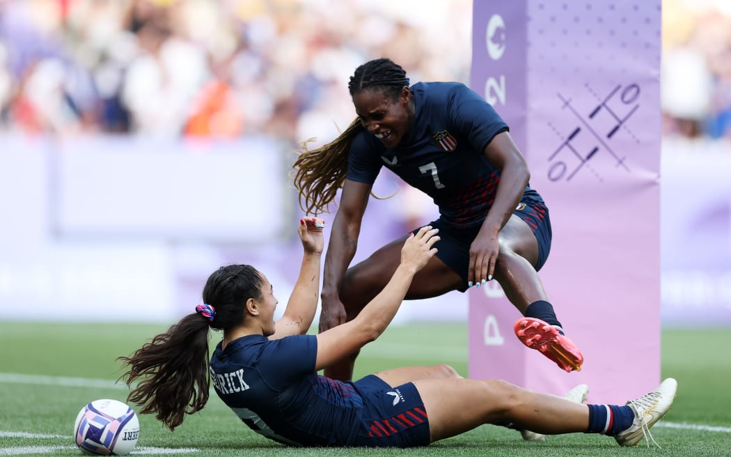 Alex Sedrick #8 of Team United States celebrates with Naya Tapper #7 of Team United States after scoring her team's second and winning try during the Women's Rugby Sevens Bronze medal match between Team United States and Team Australia.