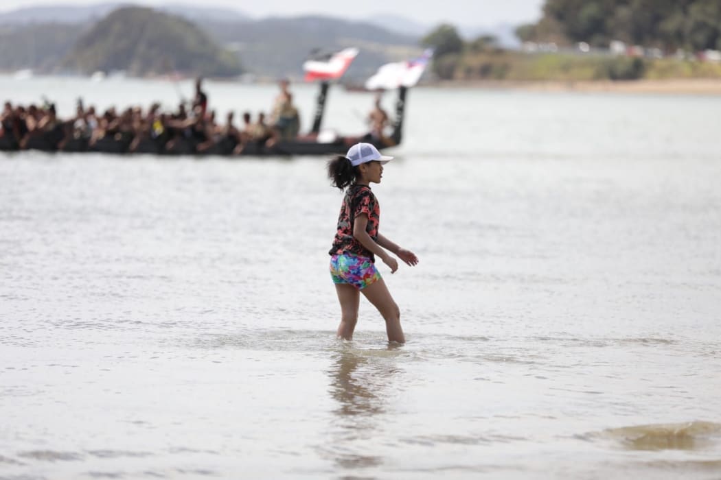 A girl walking in the water.