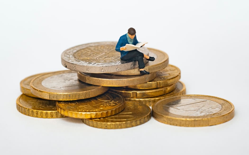 man sitting on coins