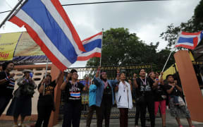 Anti-government protesters gather outside a polling station in a bid to prevent people from voting in Narathiwat, southern Thailand.