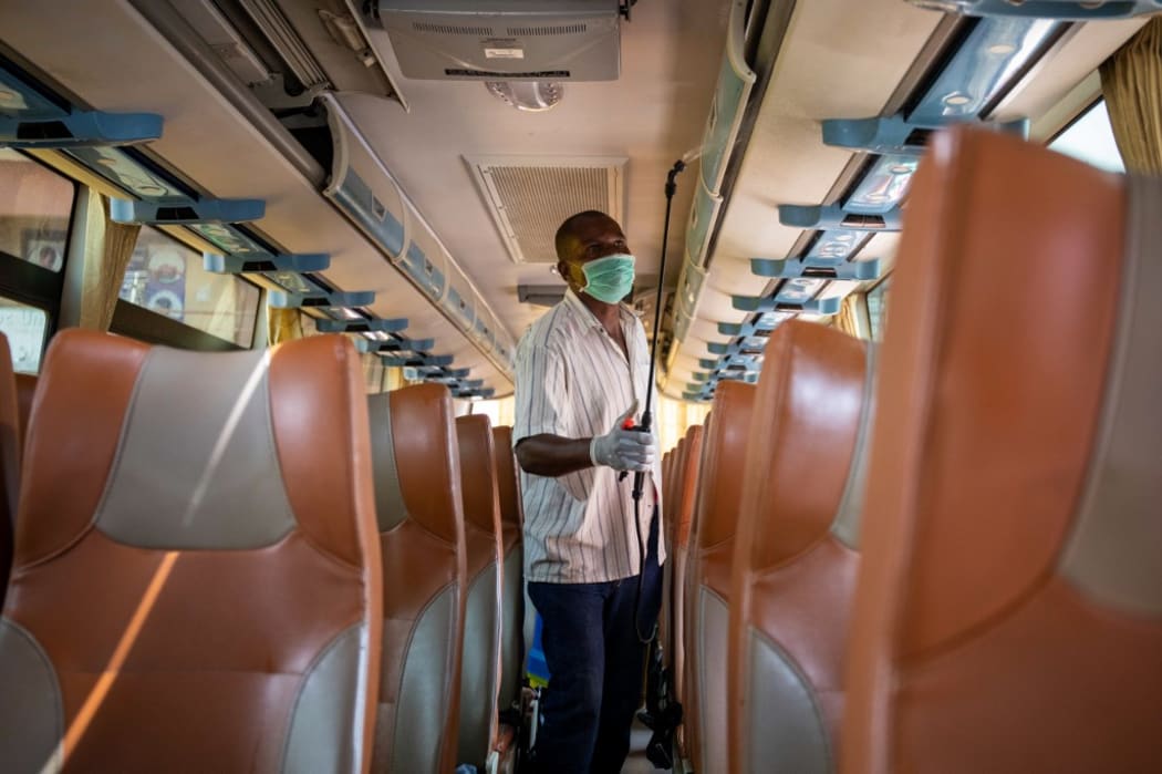 A worker of an intercity bus company disinfects the bus as a preventive measure against the spread of the COVID-19 coronavirus in Kampala, Uganda.