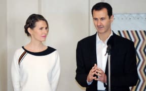 Syrian President Bashar al-Assad speaking next to his wife Asma as they receive members of the army and their mother's to celebrate Mother's Day.