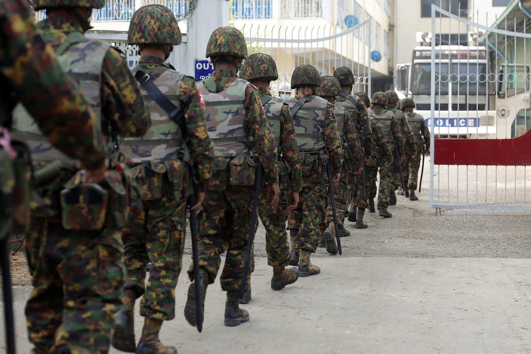 Myanmar soldiers patrol during a demonstration against the military coup outside the Central Bank in Yangon.